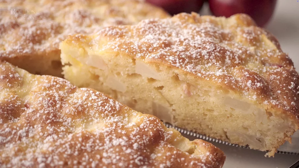 Gros plan sur la mie du gâteau aux pommes, avec morceaux de pomme visibles