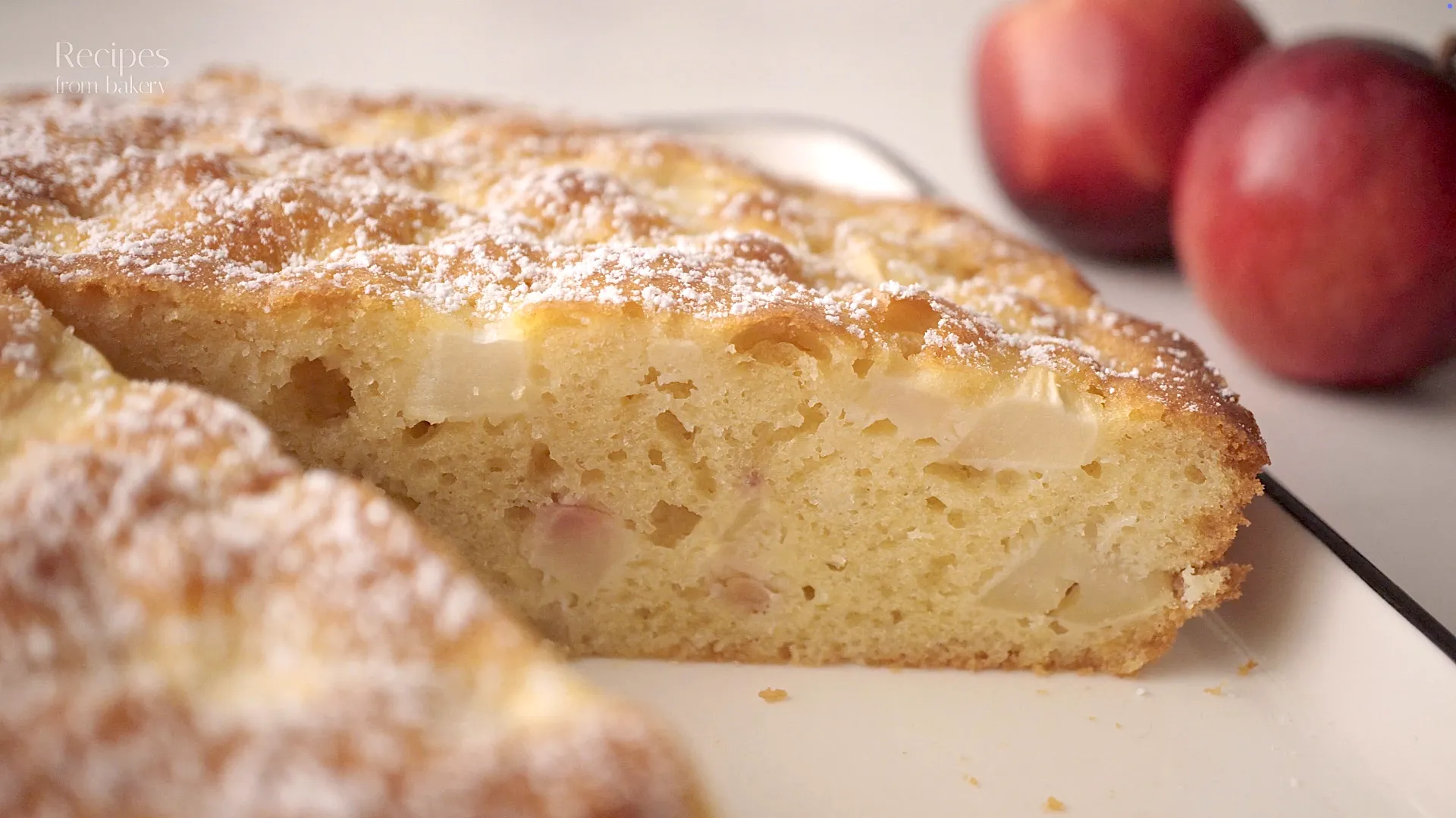 Gros plan sur la mie du gâteau aux pommes, avec morceaux de pomme visibles